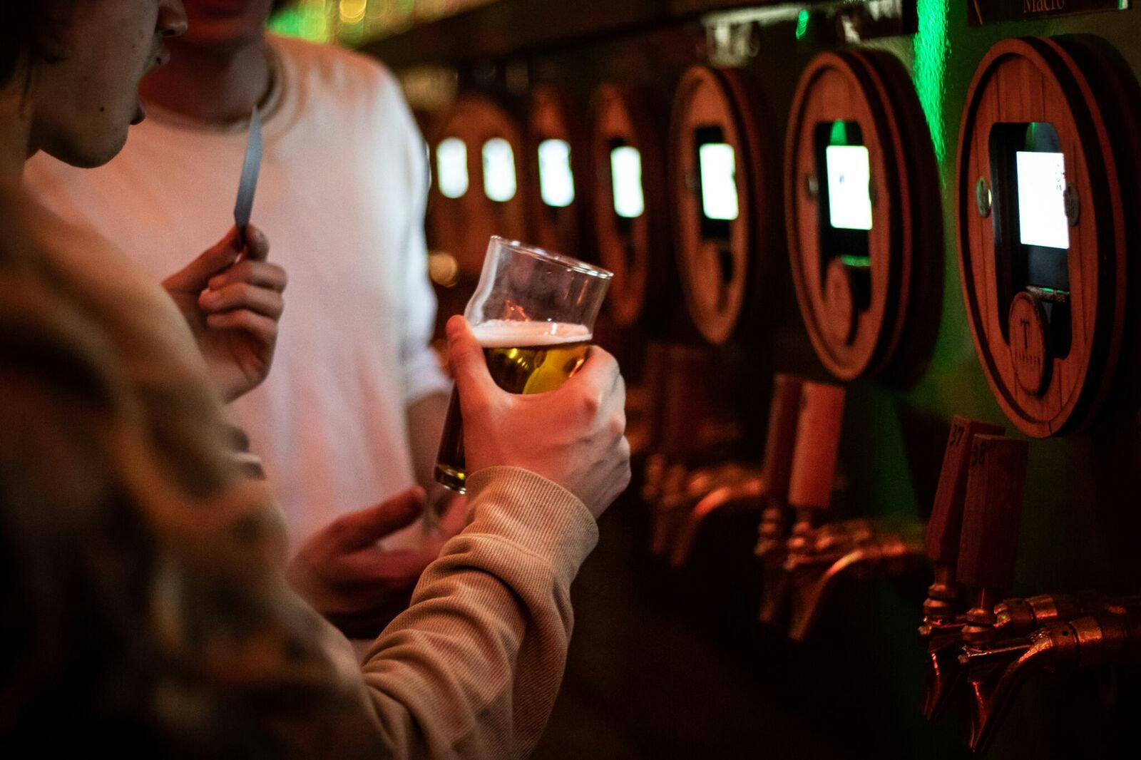 A man holding a glass of beer.
